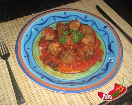 a plate of albondigas with tomato sauce