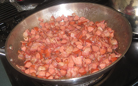 Sausage cooking with bacon