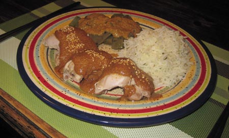 a plate of chicken with pipián